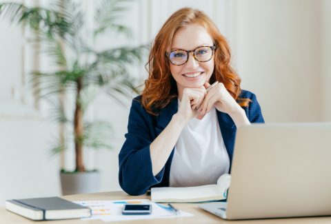 pleased-cheerful-female-economist-develops-financial-startup-project-poses-in-office-interior.jpg